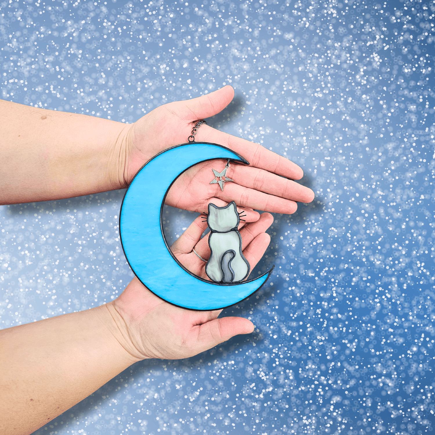 Hands holding Cat on Moon with Starts Memorial Suncatcher for Pet Loss.