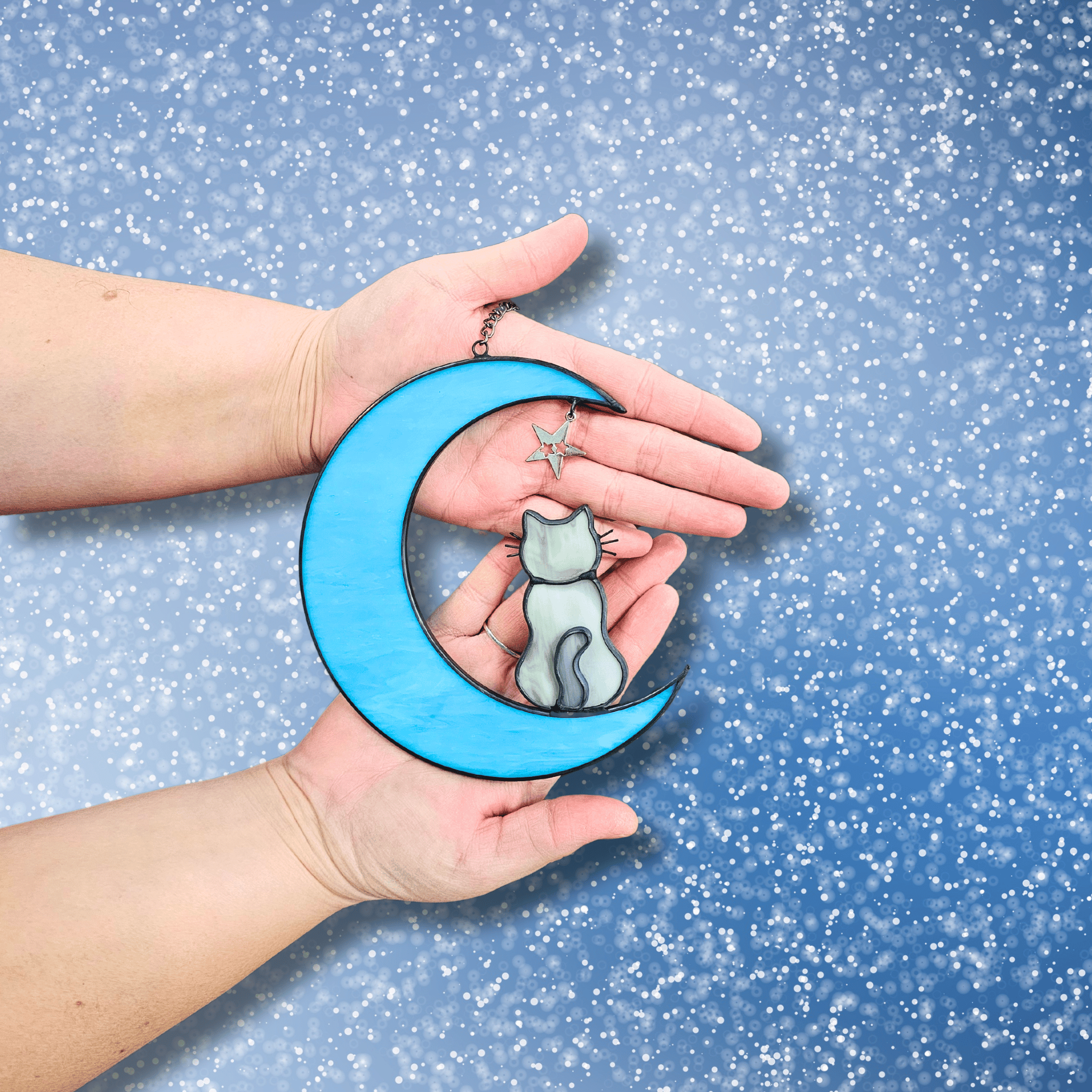 Hands holding Cat on Moon with Starts Memorial Suncatcher for Pet Loss.
