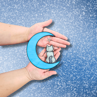 Hands holding Cat on Moon with Starts Memorial Suncatcher for Pet Loss.